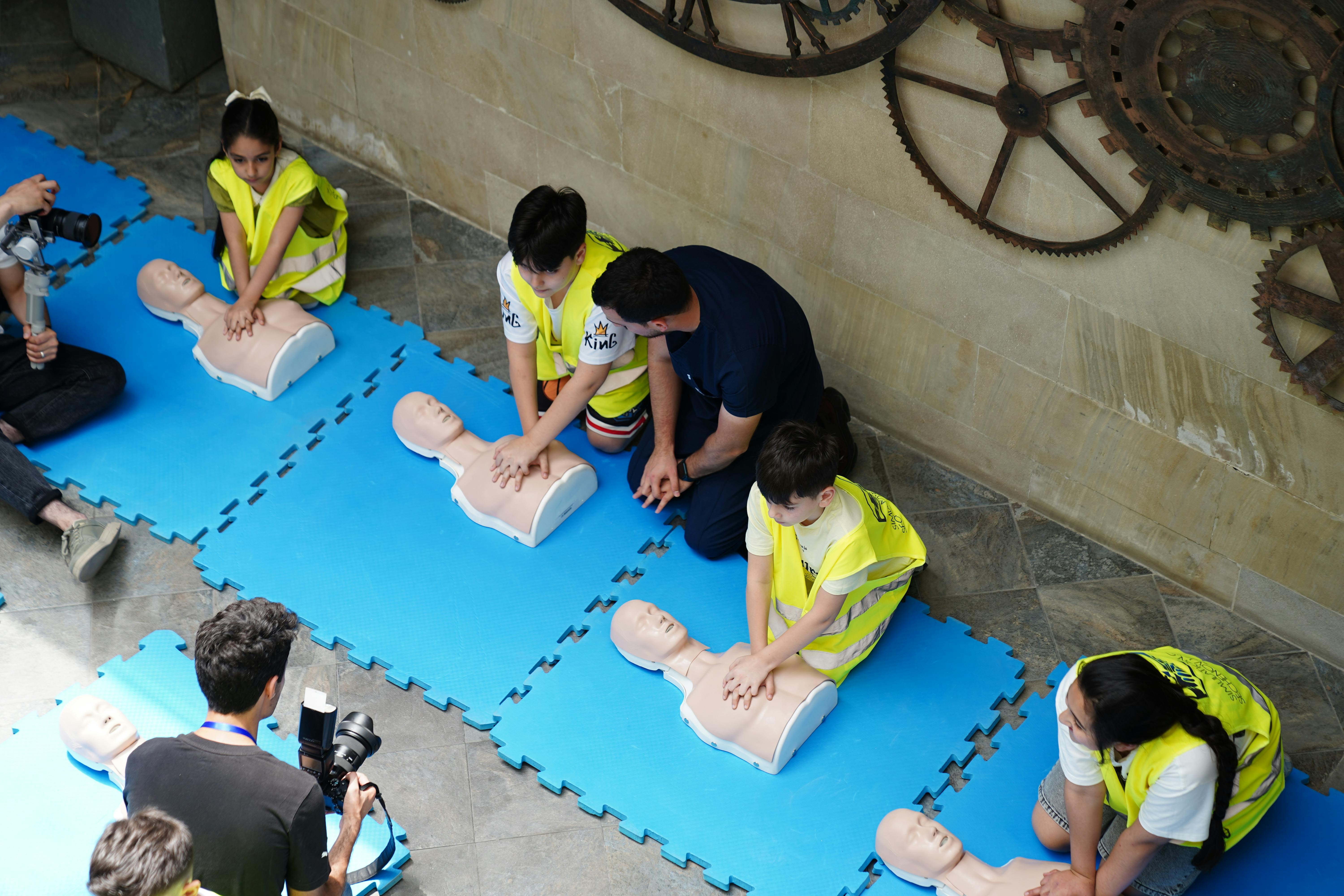 Two medical aide students in a BLS class demonstrates their BLS skills with hospital dummy