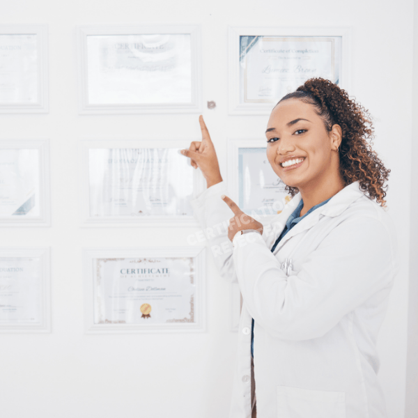  BLS certified doctor points at a BLS certificate in a wall